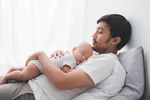 Daddy Prints: dad with his infant boy sleeping on his chest