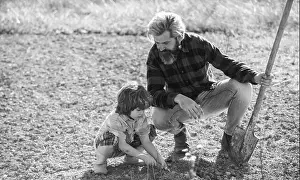 Shovel Prints: Dad with shovel and boy digging soil