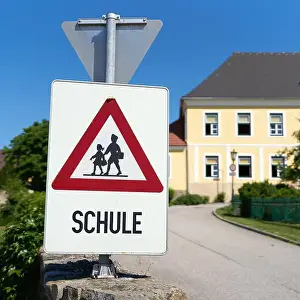 Schoolchild Prints: Danger sign indicating possible school children in the road area in the municipality of Emmersdorf in Austria
