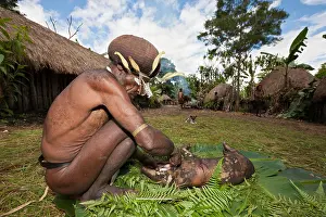 Citizens Prints: Dani Men cutting Pig at Pig Festival, Baliem Valley, West Papua, Indonesia