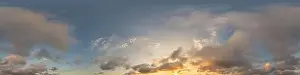 Dark blue sunset sky panorama with golden Cumulus clouds