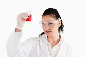 Beaker Prints: Dark-haired woman looking at a red beaker