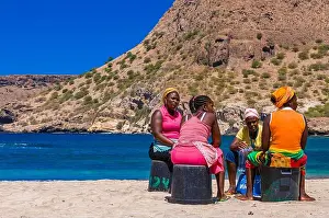 Cape Verde Prints: Dark skinned women, sitting at sandbeach and talking to each other
