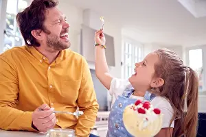 Ice Cream Prints: Daughter In Kitchen Eating Ice Cream Dessert And Putting Some On Father's Nose