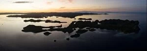 Images Dated 28th January 2020: Dawn illuminates the serene waters surrounding limestone islands in Raja Ampat, Indonesia