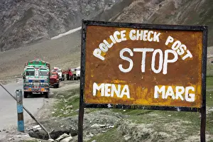 Pakistan Prints: Decorated Tata trucks parked at the Mena police checkpoint in the Himalayas on the hazardous road to Kashmir northern