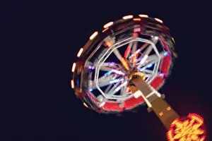 Ferris Prints: Defocused and motion blurred photo of Evolution named fun device in the izmir amusement park