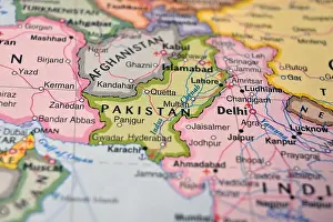 Pakistan Prints: Defocused World Map Background Showing Pakistan Location Top View Geography and Travel Concept