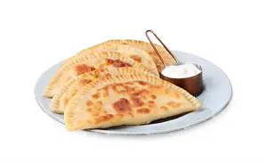 Filling Prints: Delicious fried chebureki with cheese and sauce isolated on white