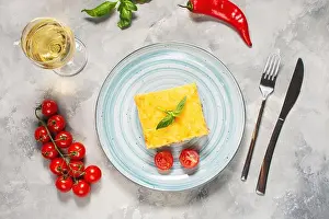Melted Prints: Delicious homemade italian Lasagna with bachamel sauce and glasses of wine on concrete background