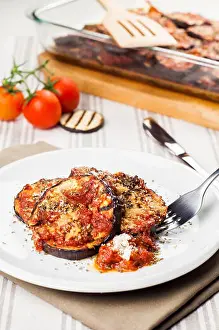 Eggplant Prints: Delicious parmigiana on white plate on table