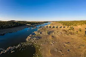 River Bridge Prints: Destroyed abandoned Ajuda bridge drone aerial view
