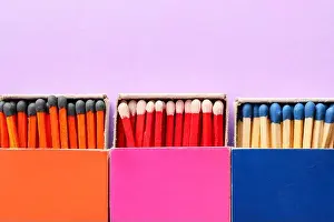 Fireplace Prints: Different boxes with matches on color background, closeup