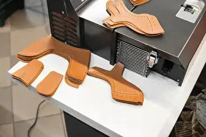 Different forms of leather pieces which will be use for making a shoes on a shoes factory. Prepared, bundled leather parts, used in the production of