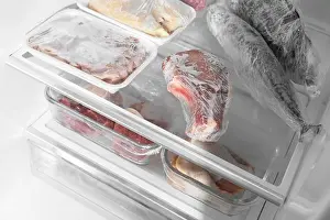 Containers Prints: Different frozen meat and fish products in fridge, closeup