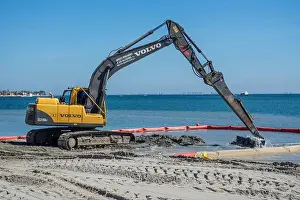Digger escavates sand form the Mar Menor in Los Alcazares in Murcia