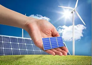 Alternative Energy Prints: Digital composite of solar panel on hand in front of different devices to renewable energy
