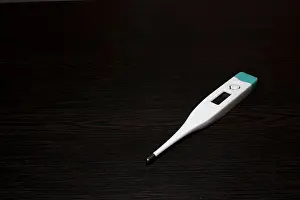 Tablets Prints: Digital Thermometer on black background to check body temperature