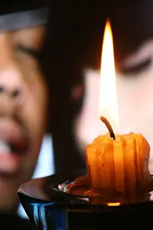 Mulatto Prints: Dim mulatto man and the white woman on a background of burning candle
