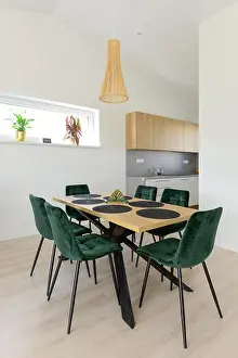 Dining table next to kitchen in contemporary house