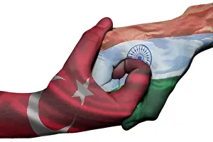 Diplomatic handshake between countries: flags of Turkey and India overprinted the two hands