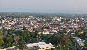 City Scape Prints: Diriamba, Nicaragua - May 26, 2024: Churches roof in Diriamba city aerial drone view on sunset time