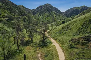 Overhead View Prints: Dirt walking trail winds up through the green hills of Southern California