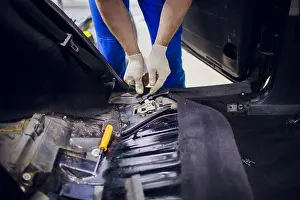 Tear Prints: dismantling of the floor in the car mechanic male man removes the floors in the car