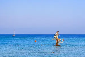 Paradise Island Prints: Diving platform in sea with a group of people wanting to jump into the water on the beach in Rhodes