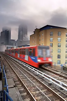 Leaving Prints: Dockland DLR train with Canary Wharf in the background London England UK