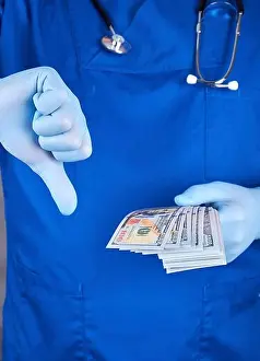 Wage Prints: doctor in blue uniform and latex gloves keeps one hand a lot of money