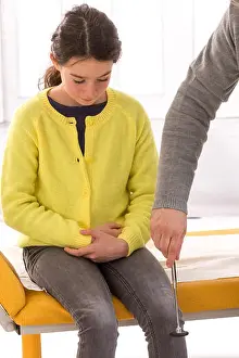 Knee Prints: Doctor checking girl knee reflex