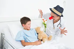 Entertaining Prints: Doctor in clown costume entertaining ill boy in hospital