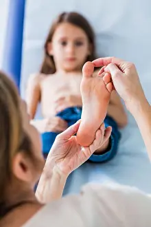 Barefooted Prints: Doctor examining girl's foot