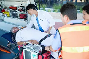 Urgency Prints: Doctor examining patient on ambulance stretcher