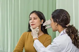 Therapist Prints: Doctor giving female patient medical injection in temporal