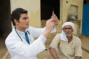 Examine Prints: Doctor giving an injection to a farmer, Hasanpur, Haryana, India