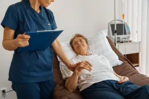 Measuring Prints: Doctor measures patient's heart rate and makes note during treatment in a hospital ward