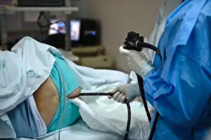 Nurses Prints: Doctor operating an endoscope to perform a colonoscopy examination procedure on a patient