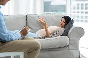 Lying Prints: Doctor writing on notepad while consulting pregnant woman