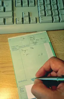 General Practitioner Prints: Doctor writing prescription for Viagra tablets for elderly male patient United Kingdom NHS Great Britain UK