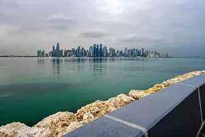 Rainy Weather Prints: Doha, Qatar - February 12, 2023: Doha Skyline view from Dhow Harbour Corniche in Rainy Weather