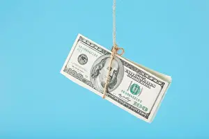 Fraud Prints: Dollars are tied on a rope, on a blue background. Isolate, free space