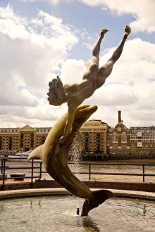Tower Bridge Prints: Dolphin and Boy Stature, Tower Bridge from St Katherines Dock on the North Bank of the River Thames