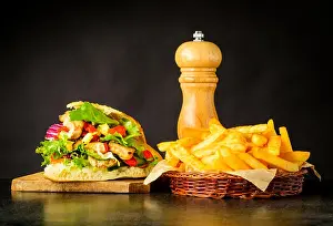 Dark Background Prints: Doner Kebab Sandwich with French Fries and Salt grinder
