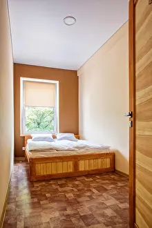 Nightstand Prints: Double Wooden bed in the room of the hostel