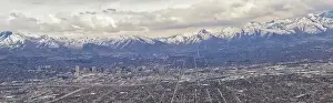 Downtown Salt Lake City Panoramic view of Wasatch Front Rocky Mountains from airplane in early spring winter with