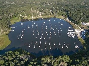 Aerial Landscape Collection: Dozens of sailboats are moored in a calm bay on Cape Cod, Massachusetts