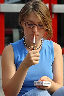 Human Interest Prints: (dpa) - The picture shows a cigarette smoking teenager girl in front of a school in Frankfurt Main