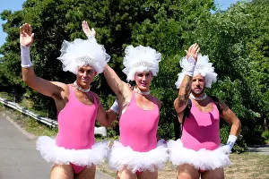 Entertaining Prints: Three drag queens dressed in pink tutus and white headdresses prepare for a Carnival parade in Provincetown